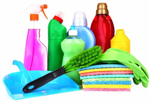 Professional home cleaners working in a Belsizepark living room