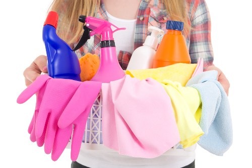 Cleaning operative using protective equipment in a Belsizepark home