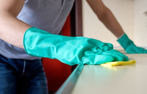 Local Belsizepark cleaning service preparing a kitchen and living area